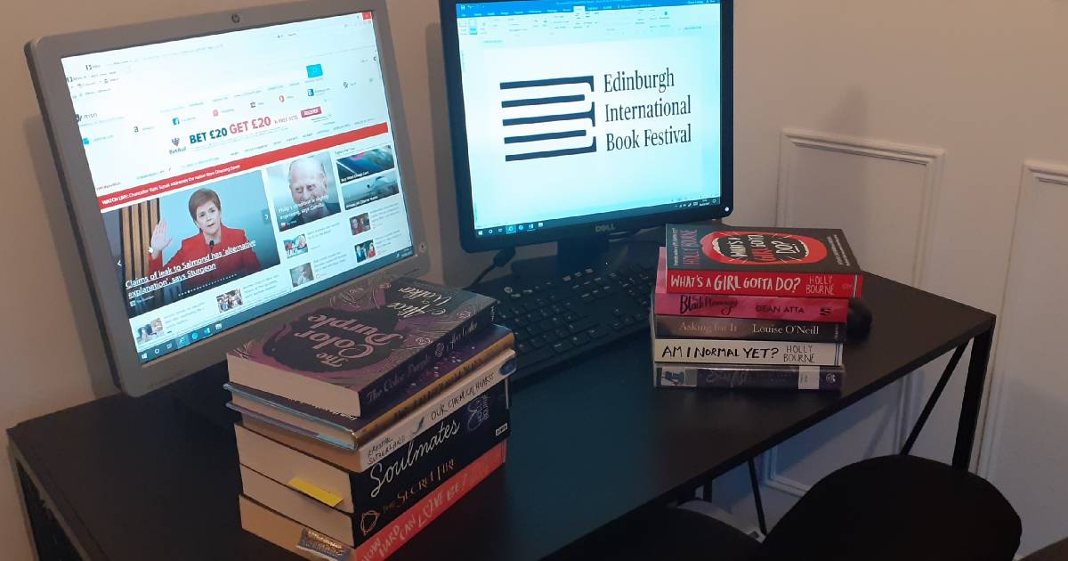 Hollie's desk with two piles of books