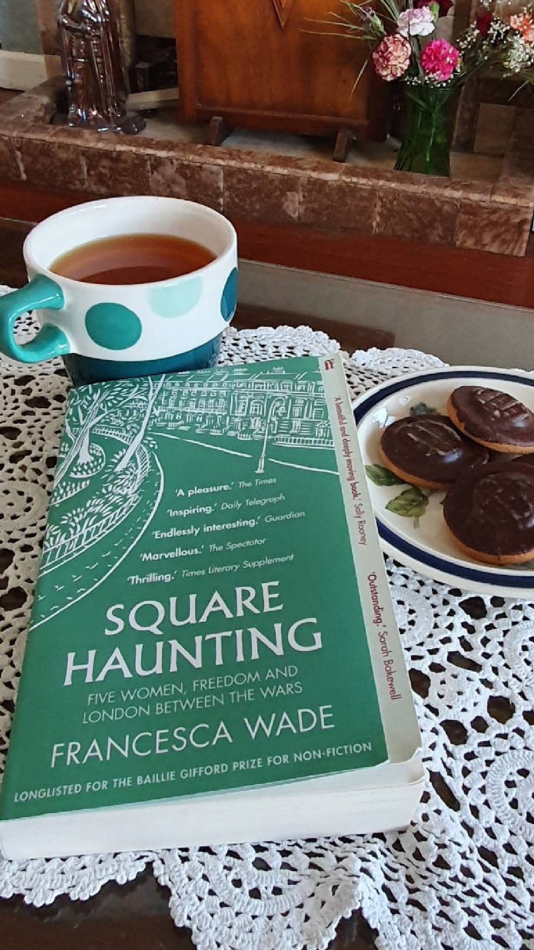 A copy of Square Haunting, with a cup of tea and jaffa cakes