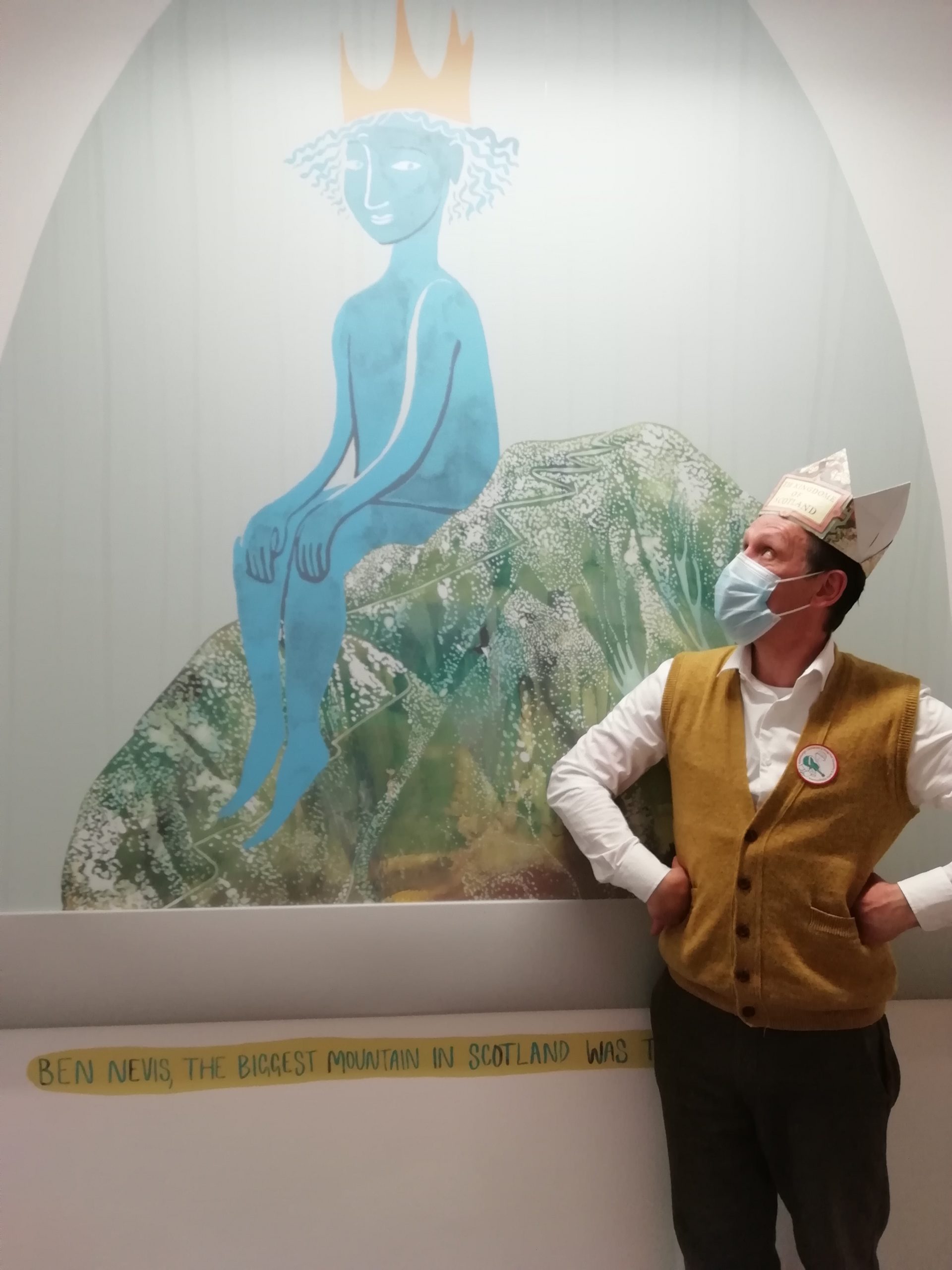 Andy Cannon wearing a crown and looking at a wall painting