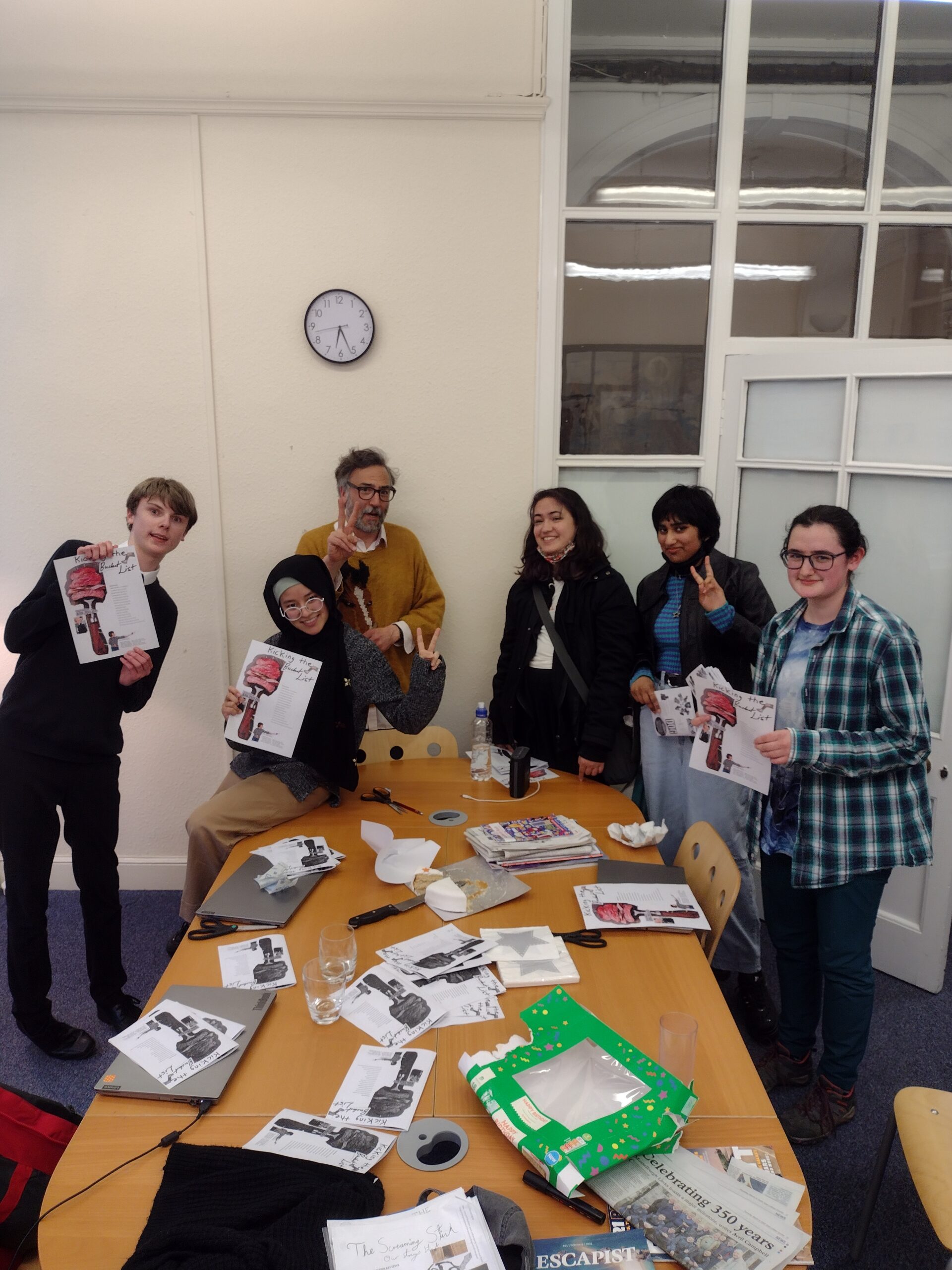 Ryan and the Collective posing with their zines